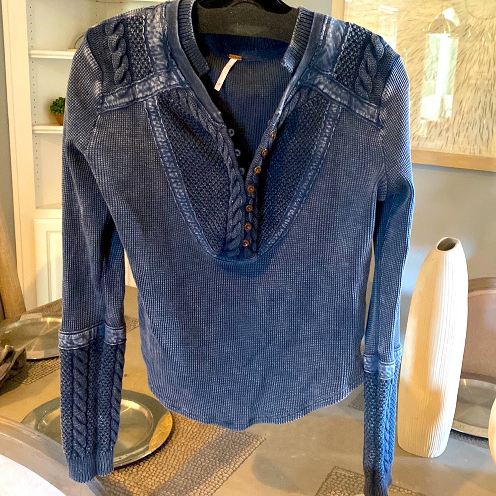 Free people 100 percent cotten top with hook/ eye button closure.